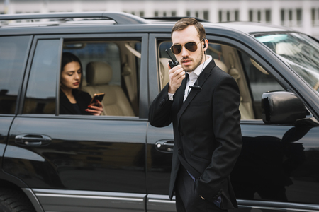 high-angle-guard-man-protecting-client (1)